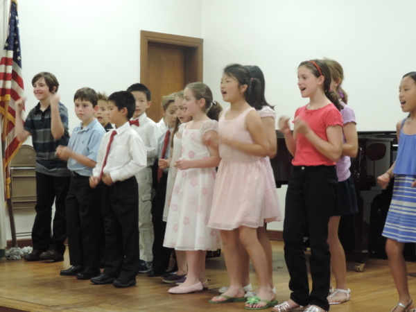 A group of children standing in front of each other.