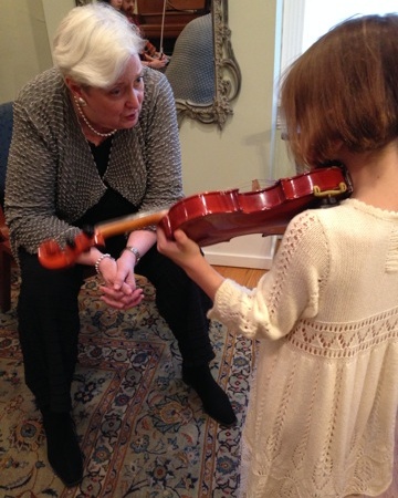 A little girl playing with an older woman.